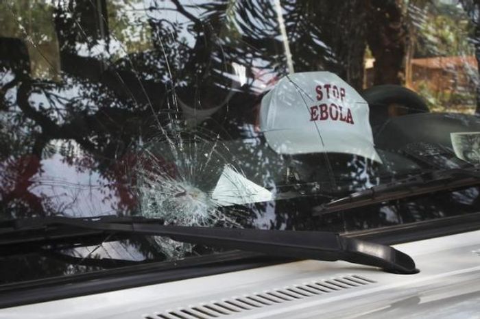 The broken windshield of an Ebola emergency team vehicle is seen after it had been pelted with stones in Lola February 9, 2015. The broken windshield of an Ebola emergency team vehicle is seen after it had been pelted with stones in Lola February 9, 2015.